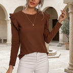 Camille brown knit top in a stone courtyard