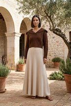 Brown sweater and beige skirt on model
