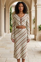 Verde striped knit cardigan and skirt set on a stone terrace