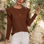 Camille brown knit top on a garden terrace