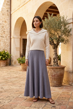 Beige sweater and grey skirt on model